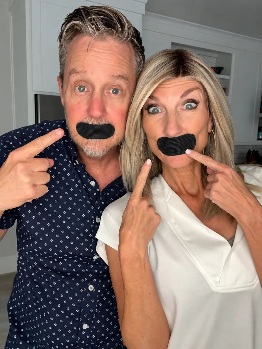 Man and woman wearing black mouth tape