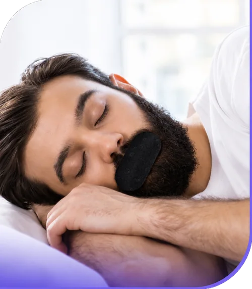 Man sleeping while wearing black mouth tape